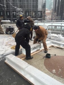 A block of ice is positioned at the base of the house at the start of construction.  Each block weighs 300 lbs.